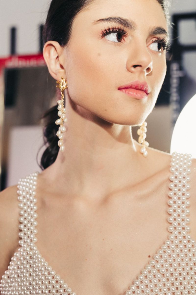 girl wearing pearl earrings