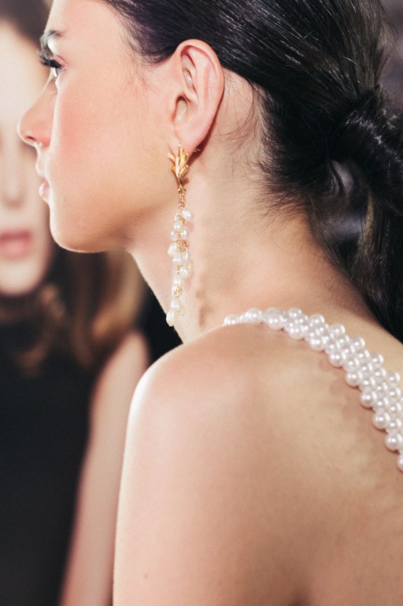 girl wearing pearl earrings