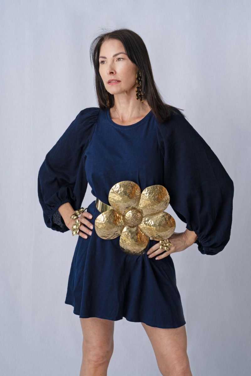 woman wearing blue dress and brass belt