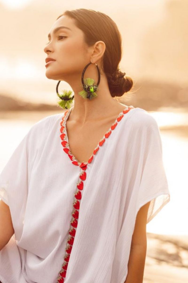 woman wearing earrings at the beach